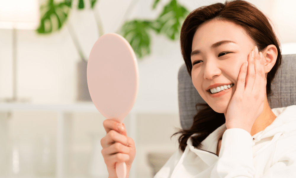 Bright skin girl looking into mirror