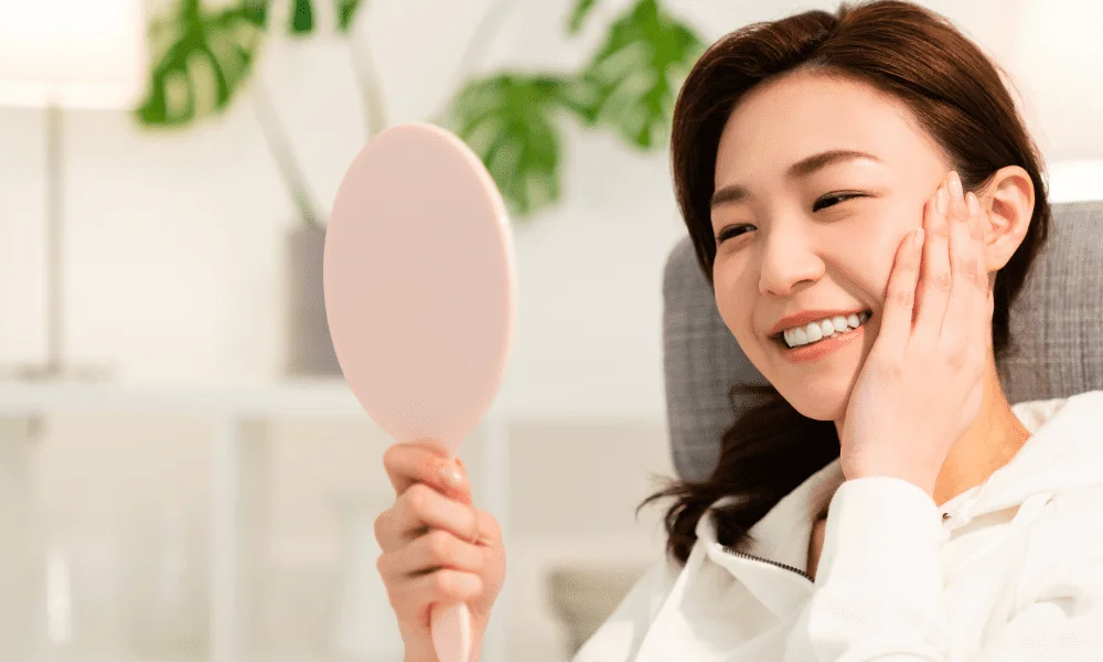 Bright skin girl looking into mirror